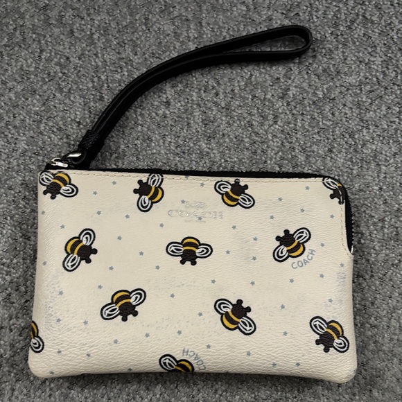 Coach Handbags - Coach Cream Wristlet with Bee Print and Black Strap